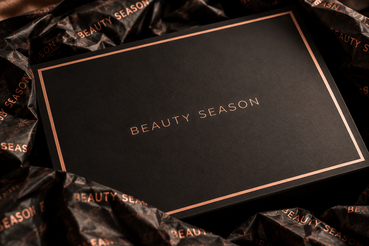 The black BEAUTY SEASON box resting on branded black tissue paper